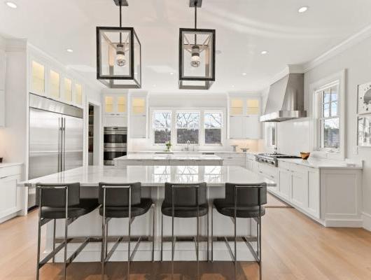 modern white kitchen with 2 big stone islands in the center